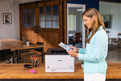 Person Retriving Paper from imageCLASS LBP674Cdw II
