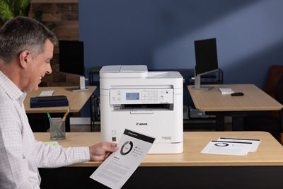 imageCLASS MF284dw - Person Looking at Printed Paper