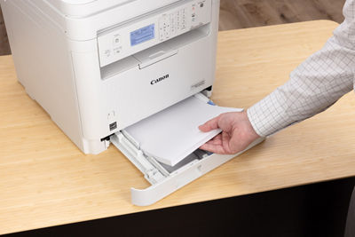 imageCLASS MF284dw - Person Looking at Printed Paper