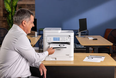 imageCLASS MF287dw - Person Looking at Printed Paper