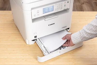 imageCLASS MF287dw - Person Looking at Printed Paper