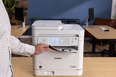imageCLASS MF287dw - Person Retrieving Printed Paper
