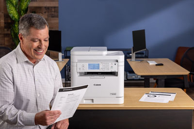 imageCLASS MF289dw - Person Looking at Printed Paper