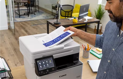 imageCLASS MF462dw - Person Using Paper Feeder to Scan