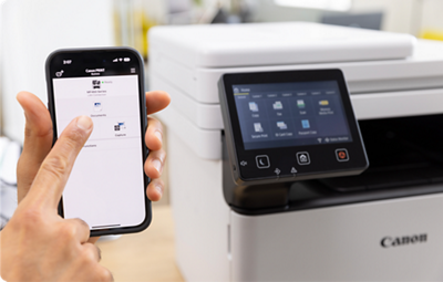 imageCLASS MF465dw - Person Holding Mobile Phone In Front of Printer