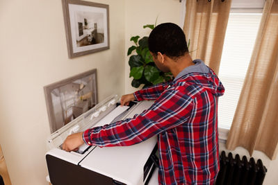 Person Refilling Paper Roll into the imagePROGRAF TC-21