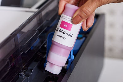 Person Refilling imagePROGRAF TC-21 Ink Tank With Ink Bottle
