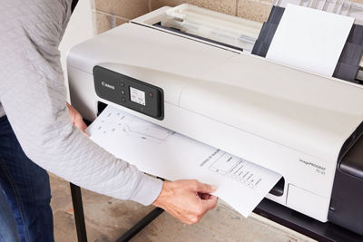 Person Getting Printed Document from the imagePROGRAF TC-21