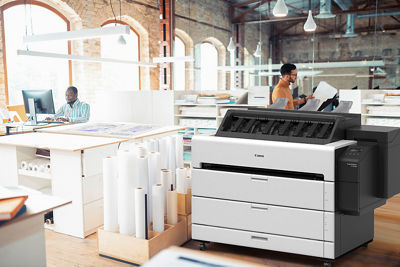 Designer checking output standing next to imagePROGRAF TZ 32000 printer