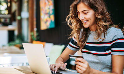 Image of a woman paying a bill on a computer