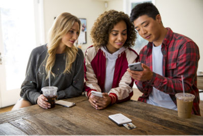 Group of friends using the ivy mini photo printer