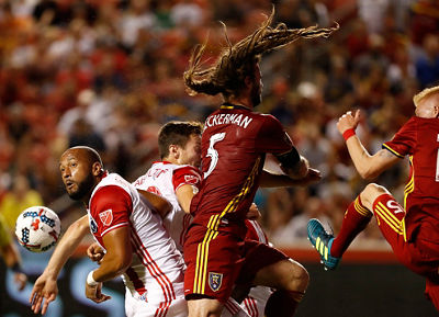 soccer action image - multiple players going for the ball