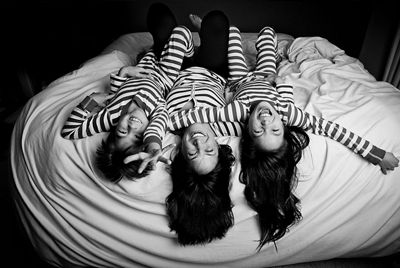 black and white photo of family lying on bed
