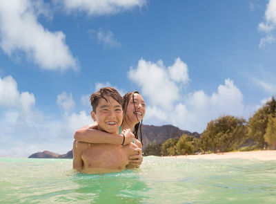 Laura's two children hugging and playing in the water
