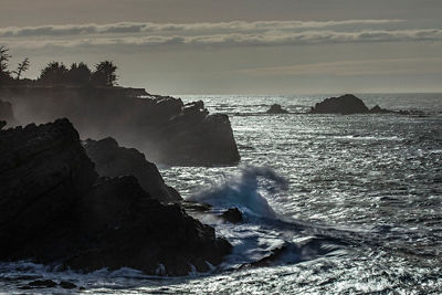 Coastal image of waves crashing on large rocks
