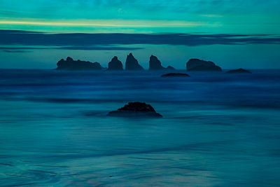 landscape image of blue waters with jutting rocks