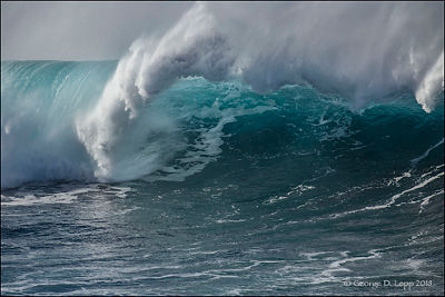 Close up image of a wave crashing - forming a spiral