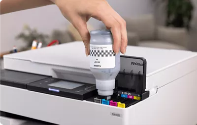 MAXIFY GX1020 - Person Filling Ink Tanks with Ink Bottle