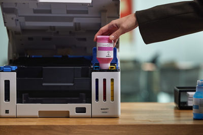 MAXIFY GX5120 - Person Using Ink Bottle to Refill Printer