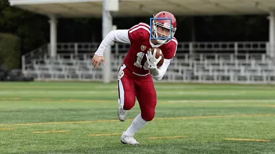 Football Player Running with a Football in Hand