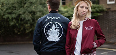 Woman facing the camera wearing a red jacket and a man facing away wearing a black jacket