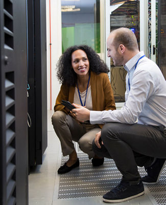 man and woman working in a data center