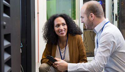 man and woman working in a data center