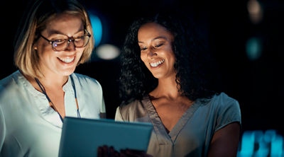 two women working on a tablet