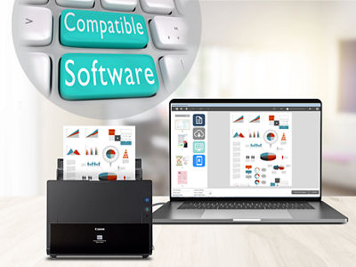 Photo of Canon scanner by a laptop on a desk.