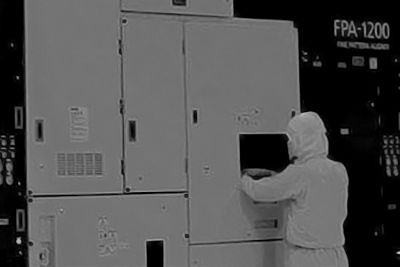 Technician working on Canon lithography equipment.