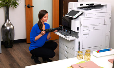 Image of a woman changing a toner cartridge