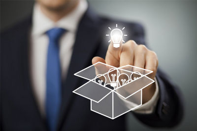 Man pressing a graphic of a lightbulb that is above a graphic of a box full of lightbulbs