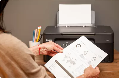 PIXMA G3270 - Person Holding Printed Paper