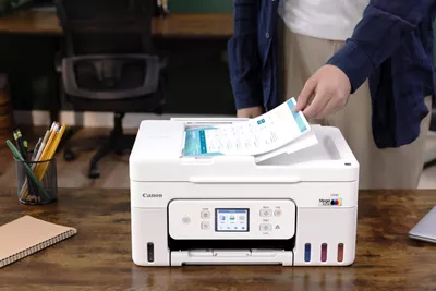 PIXMA G4280 - Person Putting Paper in Auto Feeder