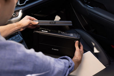 Person Charging The PIXMA TR160 In a Car