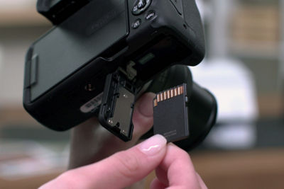 PIXMA TS8820 - Person Removing Memory Card from a Camera