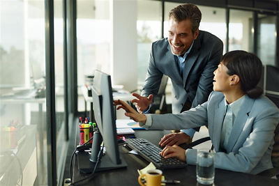Image of a businessman and woman looking at a computer screen