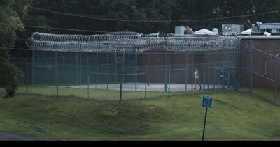 Reality Winner running in caged outdoor area