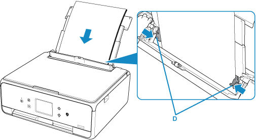 Paper guides shown aligned on the side of the paper