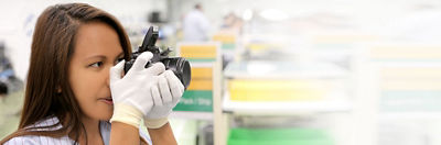 Canon repair service employee inspecting a camera