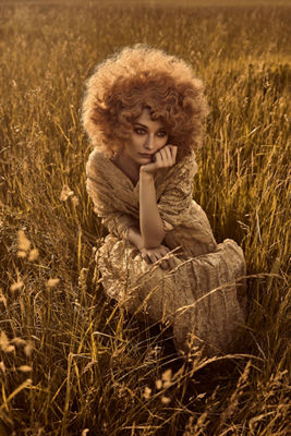 Person in Beige Sitting in a Wheat Field