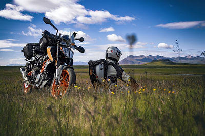 Motorcyclist with Motorcycle Sitting in a Field