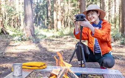 Person Using a Camera to Record a Campfire