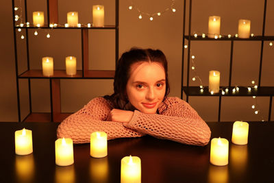 Person Posing Surrounded by Candles