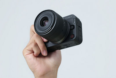 Person Holding the RF-S14-30mm F4-6.3 IS STM PZ Attached to a Camera