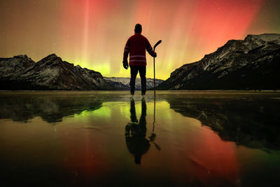 Hiker with Aurora Borealis in the Sky