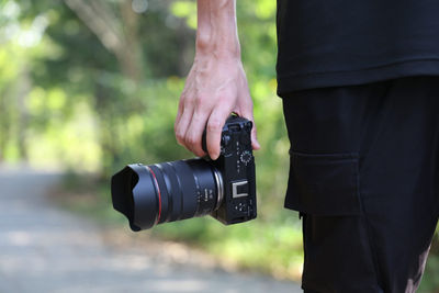 Person Holding Camera with RF20-50mm F4 L IS US PZ Lens