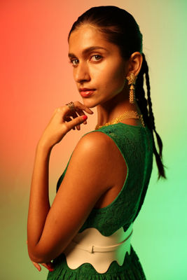 Person Posing With a Orange and Green Background