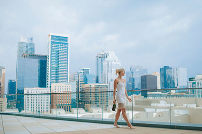 Person Walking on a Sidewalk With a City Background