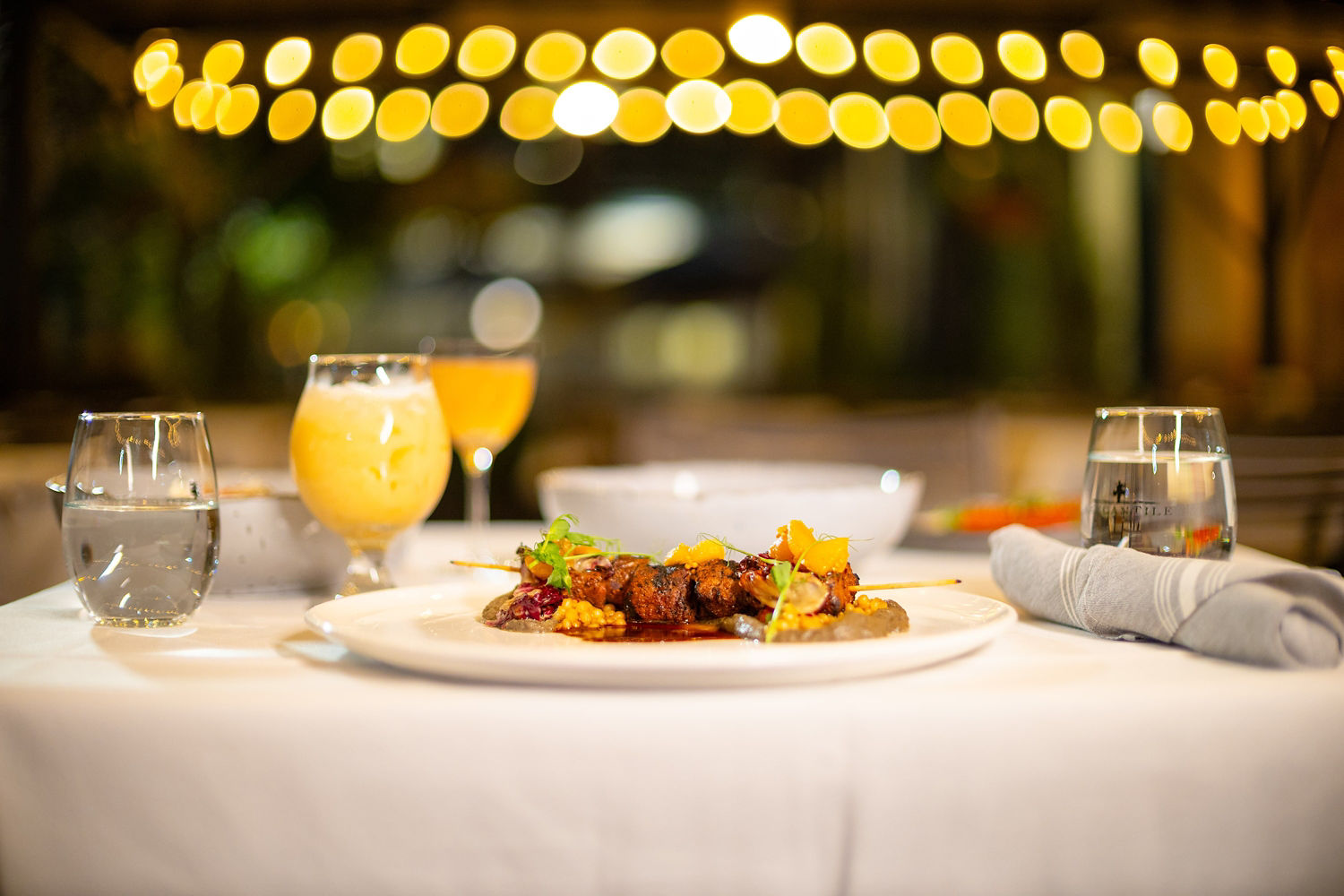 Food Served on a Plate Surrounded by Drinks